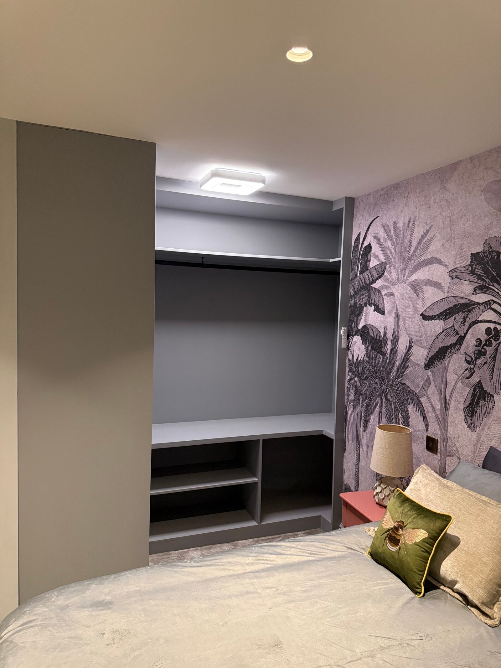 Bedside closet with tropical wallpaper.| Julian Bespoke Interiors
